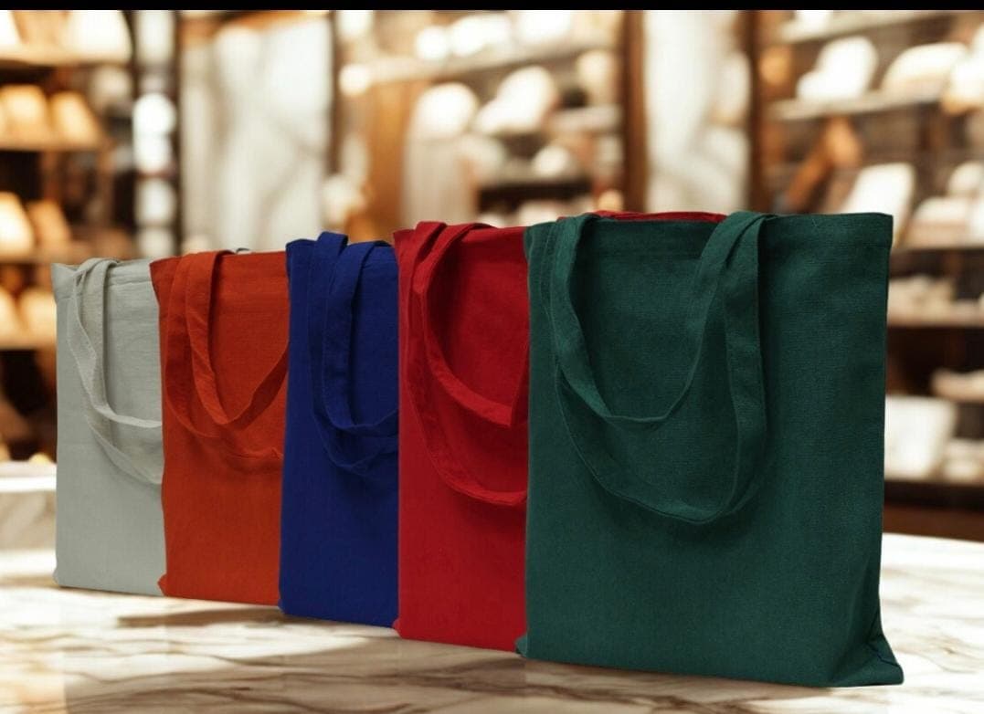 A curated collection of colorful reusable tote bags in a retail setting.