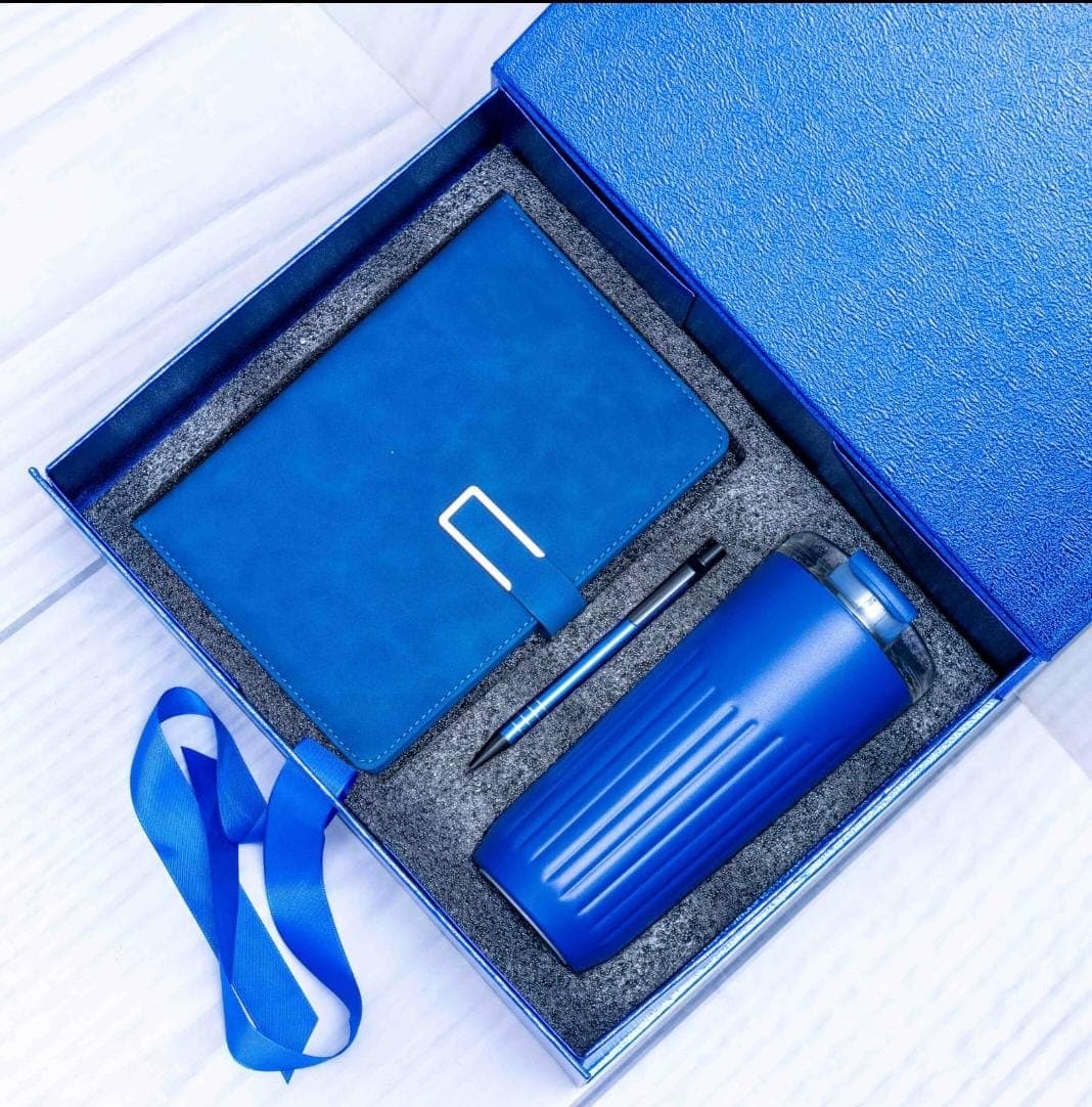 A blue executive gift-set concept containing a bottle, notebook and pen.